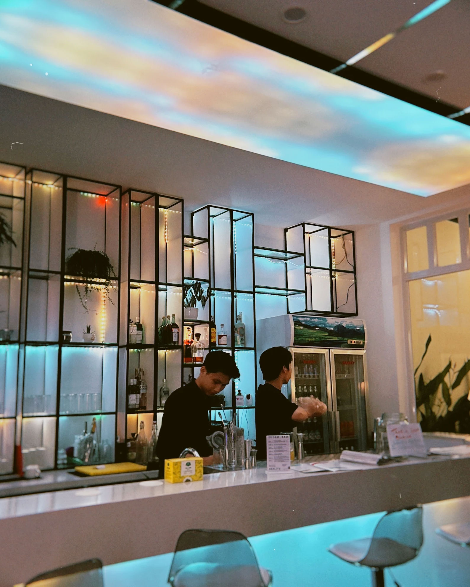 Bar with illuminated ceiling and shelves