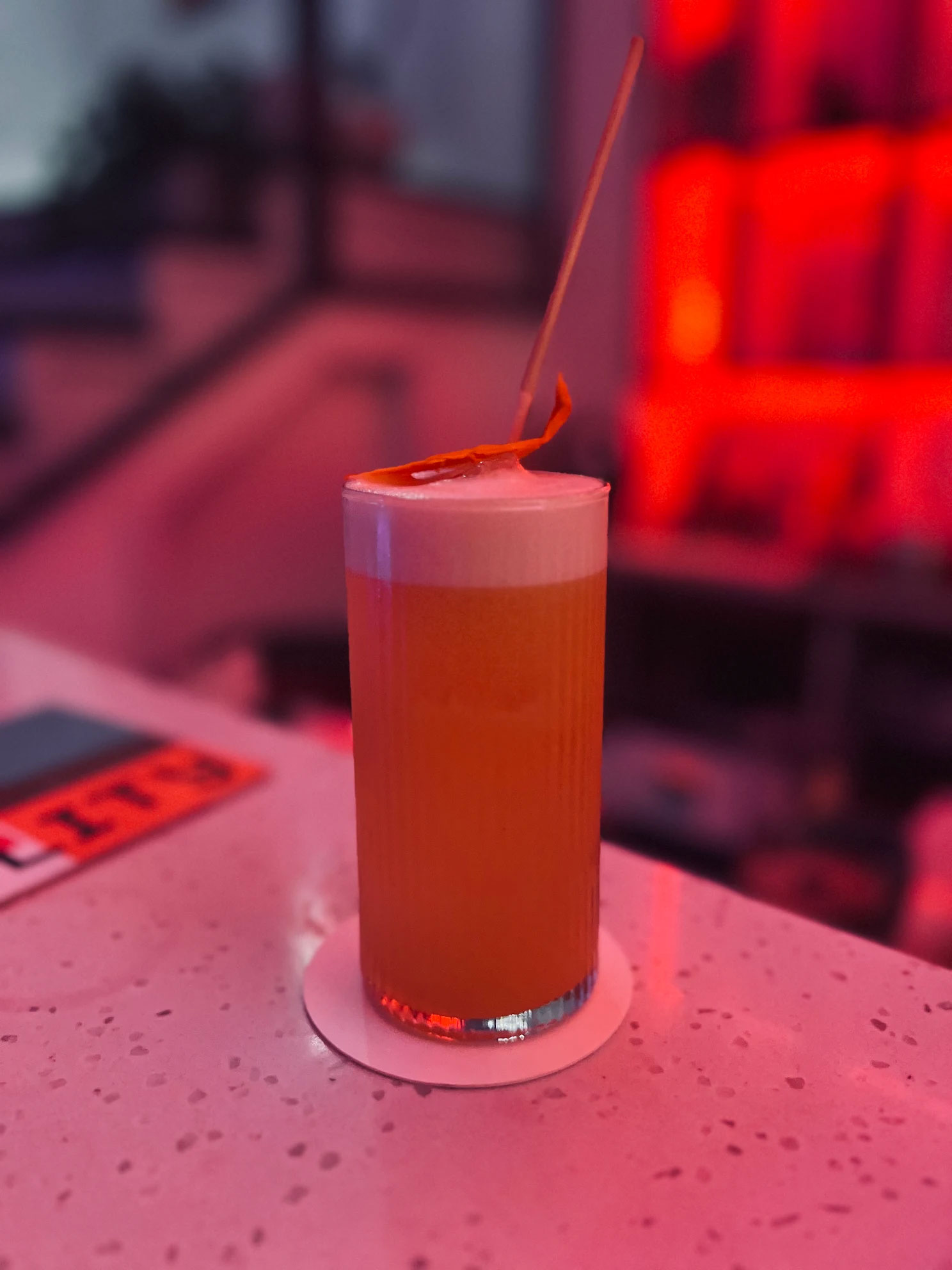 Cocktail with foam and citrus garnish