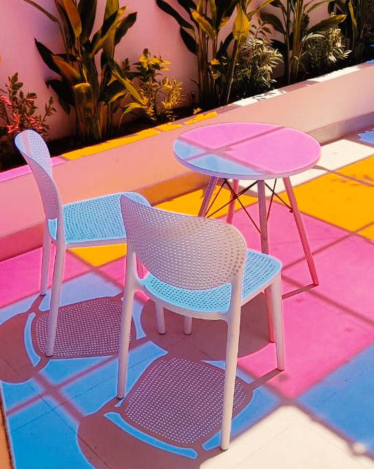 Outdoor seating with colorful shadows